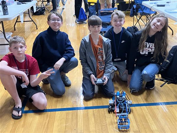 Students pose with their robot.